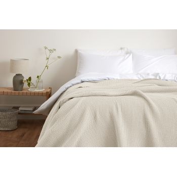 Image featuring a cotton bedspread in various soft pastel colors